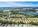 Aerial view of community with lake and surrounding landscape at 5825 Princess Caroline Pl, Leesburg, FL 34748