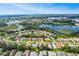 Expansive aerial view of a beautiful residential community surrounded by picturesque lakes and lush greenery at 5825 Princess Caroline Pl, Leesburg, FL 34748