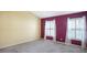 Bedroom with carpeting, two windows with shutters, and two-tone paint at 5825 Princess Caroline Pl, Leesburg, FL 34748