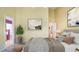 Staged bedroom featuring a decorative painting and a view of the en-suite bathroom at 5825 Princess Caroline Pl, Leesburg, FL 34748
