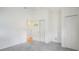 Neutral bedroom featuring a closet and views into the hallway and a bathroom at 5825 Princess Caroline Pl, Leesburg, FL 34748