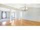 Dining room with hardwood floors and views to the living room and front door at 5825 Princess Caroline Pl, Leesburg, FL 34748