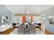 Formal dining room with chandelier, hardwood floors, and views to the outside at 5825 Princess Caroline Pl, Leesburg, FL 34748