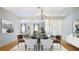 Staged dining room with chandelier and stylish furniture at 5825 Princess Caroline Pl, Leesburg, FL 34748