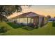 House exterior showcasing backyard and screened enclosure at 5825 Princess Caroline Pl, Leesburg, FL 34748