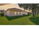 House exterior showcasing backyard lawn and landscaping at 5825 Princess Caroline Pl, Leesburg, FL 34748