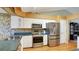 Modern kitchen featuring stainless steel appliances and white cabinets at 5825 Princess Caroline Pl, Leesburg, FL 34748