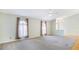 Spacious living room with hardwood floors, large windows, and views to other rooms at 5825 Princess Caroline Pl, Leesburg, FL 34748