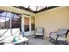 Cozy screened porch with seating area, perfect for relaxing at 5825 Princess Caroline Pl, Leesburg, FL 34748