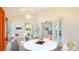 Relaxing sunroom with wicker furniture, opening into dining and living spaces at 5825 Princess Caroline Pl, Leesburg, FL 34748