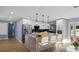 Modern kitchen with stainless steel island and white cabinetry at 1925 Blossom Ln, Maitland, FL 32751