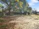 Large backyard with mature trees and a shed at 1111 N Hart Blvd, Orlando, FL 32818