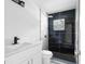 Modern bathroom with black and white tile and a walk-in shower at 1111 N Hart Blvd, Orlando, FL 32818