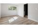 Bedroom with wood-look floors and ensuite bath at 1111 N Hart Blvd, Orlando, FL 32818