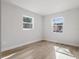 Bright bedroom with two windows and light floors at 1111 N Hart Blvd, Orlando, FL 32818