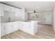 Modern white kitchen with island and stainless steel appliances at 1111 N Hart Blvd, Orlando, FL 32818