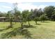 Large backyard with trees and grass at 202 Sweetwater Club Blvd, Longwood, FL 32779