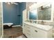 Contemporary bathroom with stone walls, double sink vanity and large frameless shower enclosure at 202 Sweetwater Club Blvd, Longwood, FL 32779