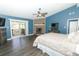 Comfortable main bedroom featuring a stone fireplace, ceiling fan, and sliding door to the balcony at 202 Sweetwater Club Blvd, Longwood, FL 32779