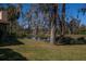 Serene backyard with pond, lush grass, and large trees at 4423 Real Ct, Orlando, FL 32808