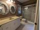 Bathroom features a vanity, toilet, shower, and decorative mirrors at 4423 Real Ct, Orlando, FL 32808