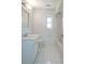 Bright, all-white bathroom featuring tile floors and shower-tub combo at 4423 Real Ct, Orlando, FL 32808