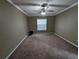 Large carpeted bedroom with a window and ceiling fan at 4423 Real Ct, Orlando, FL 32808