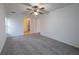 Bedroom with neutral carpet, ceiling fan, and a walk-in closet at 4423 Real Ct, Orlando, FL 32808