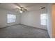 Bedroom with neutral carpet, ceiling fan, and ample natural light from two windows at 4423 Real Ct, Orlando, FL 32808