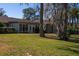 Back of house, featuring sunroom and mature trees at 4423 Real Ct, Orlando, FL 32808