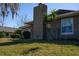 House exterior showcasing a chimney, landscaping, and a partial view of the backyard at 4423 Real Ct, Orlando, FL 32808