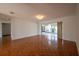 Spacious living room with hardwood floors with view into the adjacent sunroom at 4423 Real Ct, Orlando, FL 32808