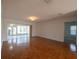 Spacious living room with hardwood floors and view to bright sunroom at 4423 Real Ct, Orlando, FL 32808