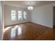 Sunny living room with windows and light fixture highlighting the wood floors at 4423 Real Ct, Orlando, FL 32808