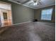 Spacious living room with carpeted floors and a ceiling fan at 4423 Real Ct, Orlando, FL 32808