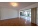 Spacious living room featuring wood floors and sliding doors to the screened patio at 4423 Real Ct, Orlando, FL 32808