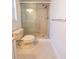 Close up of the bathroom shower with glass doors and a white toilet at 4423 Real Ct, Orlando, FL 32808