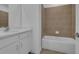 Clean bathroom with tub shower and white vanity at 5554 Stockade Blvd, Saint Cloud, FL 34771