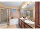 Elegant bathroom with double vanity and soaking tub at 906 Charo Pkwy # 433, Davenport, FL 33897