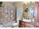 Bathroom with granite vanity and snowman shower curtain at 906 Charo Pkwy # 433, Davenport, FL 33897