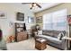 Comfortable living room featuring a grey sofa and wood cabinet at 906 Charo Pkwy # 433, Davenport, FL 33897