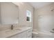 A bright bathroom boasts modern finishes, a decorative tile accent, a single vanity, and a shower-tub combination at 1020 W Princeton St, Orlando, FL 32804
