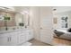 Bright bathroom with double sinks, white cabinetry, quartz countertops, and view to bedroom at 1020 W Princeton St, Orlando, FL 32804