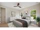 Sun-filled bedroom with ceiling fan, modern dresser, and comfortable bed at 1020 W Princeton St, Orlando, FL 32804