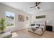 A serene bedroom featuring large windows, light walls, and a ceiling fan at 1020 W Princeton St, Orlando, FL 32804