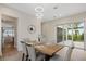 Bright dining room featuring a wooden table, upholstered chairs, modern lighting, and access to an outdoor patio at 1020 W Princeton St, Orlando, FL 32804