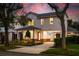Charming two-story home with a well-manicured front yard at sunset at 1020 W Princeton St, Orlando, FL 32804