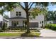 Two-story home with a modern design, visible front yard landscaping, and a two-car garage underneath the main structure at 1020 W Princeton St, Orlando, FL 32804