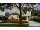 Two-story home with a modern design, visible front yard landscaping, and a two-car garage underneath the main structure at 1020 W Princeton St, Orlando, FL 32804