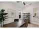 Bright office with a wooden desk, decorative artwork, and view into the ensuite bathroom at 1020 W Princeton St, Orlando, FL 32804
